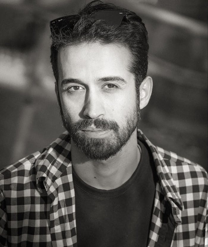 A Male Looking at Camera in Black and White 